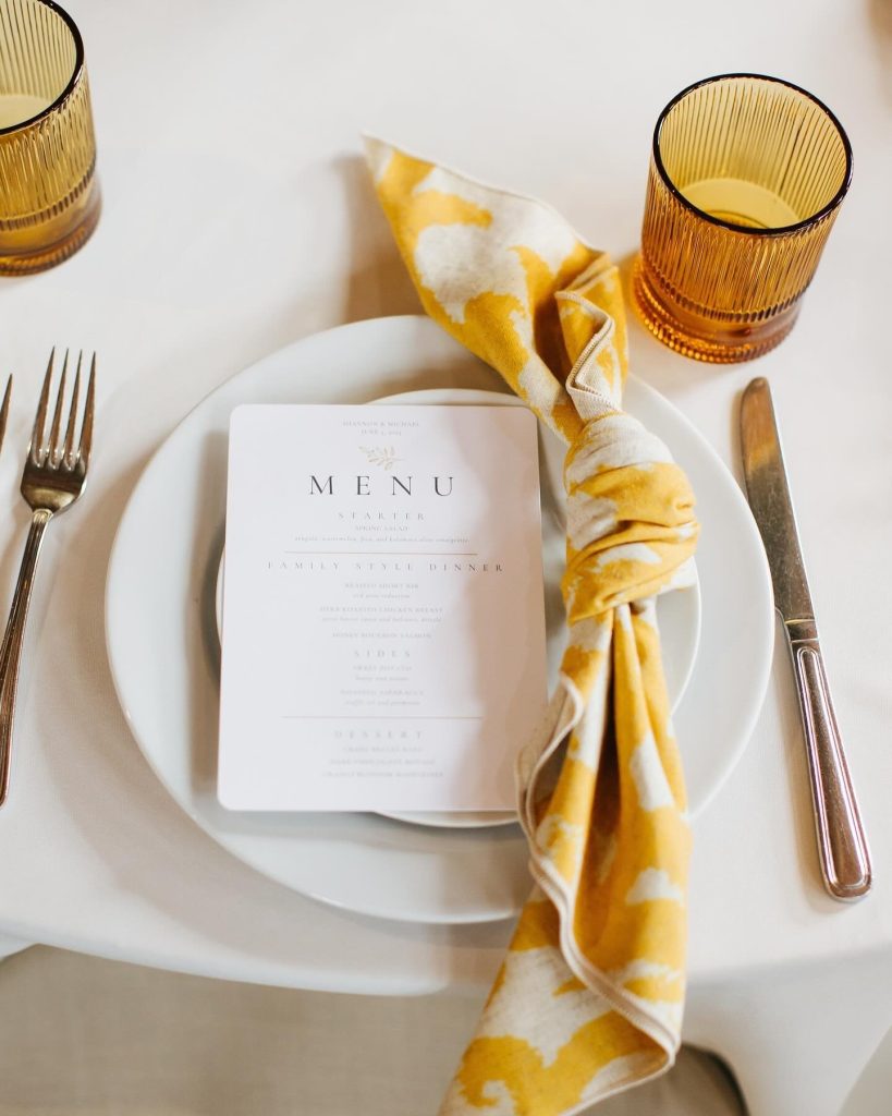 “Shannon and Michael’s vision was brought to life by ashleynicoleaffair, with pops of color from their mustard, floral napkins through