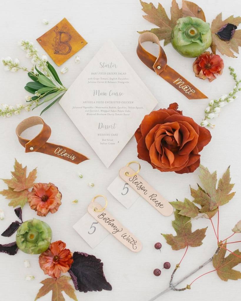 callirosa calligraphy is next level. Her signature personalized leather escort cards are a fun element to add and doubles as