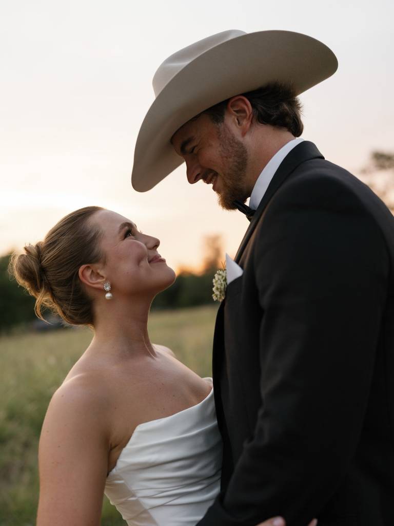Swipe to see Hensley’s Hill Country wedding day at camphideawayretreat, filled with soft, romantic touches, from dainty bows to lace-detailed