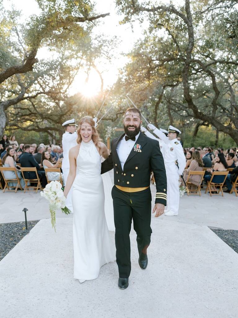 “As a tribute to my husband’s years of service flying in the Navy, we made our exit as newlyweds beneath